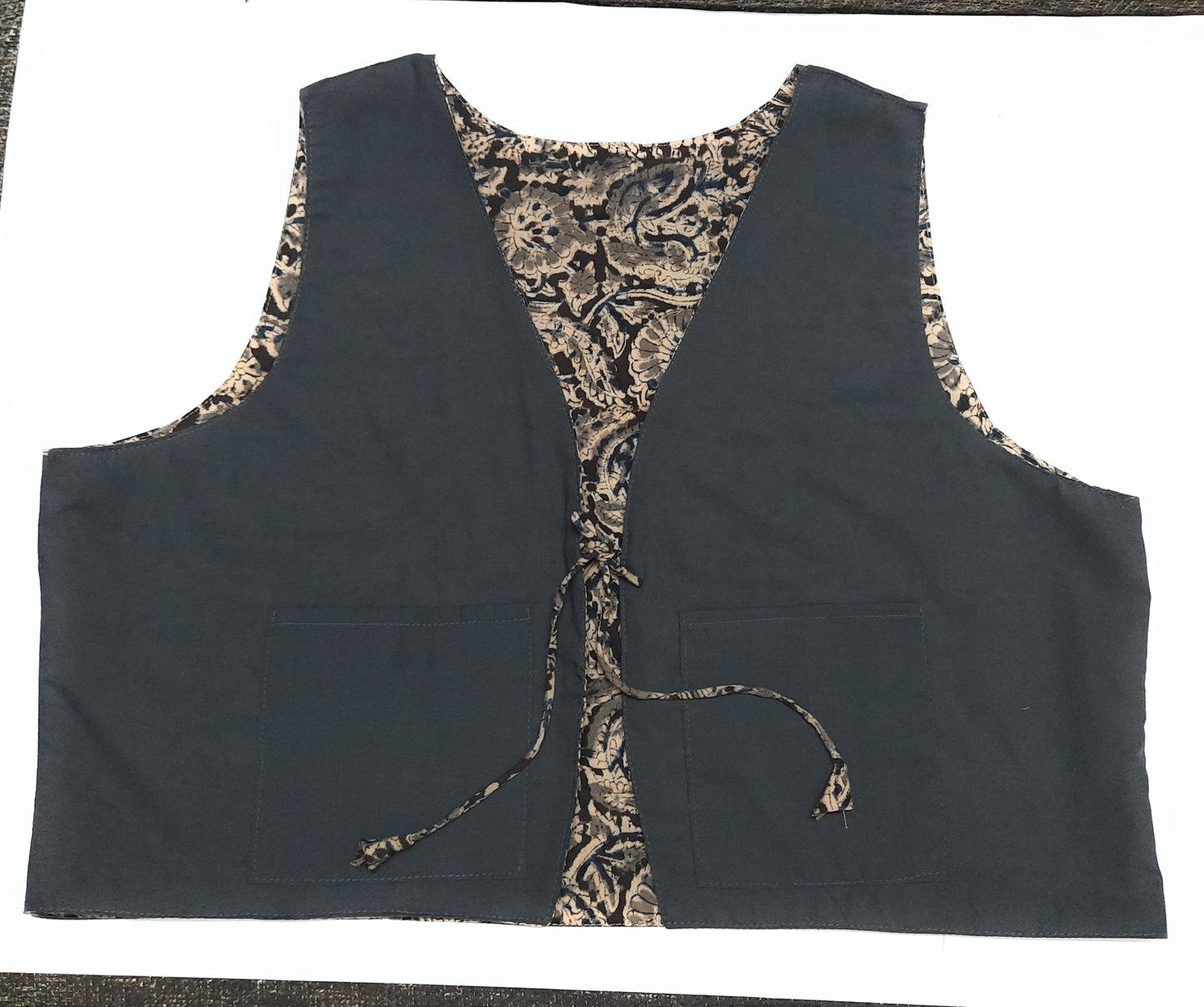 Black vest with camouflage lining on a white background
