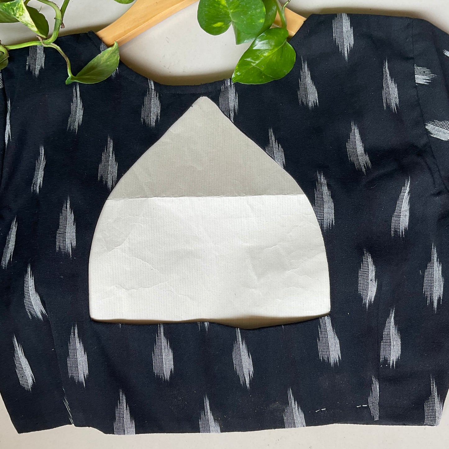 Black blouse with white abstract pattern on a white background