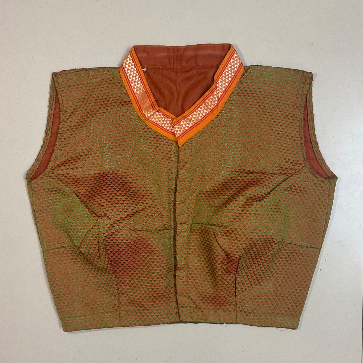 Green vest with orange trim on a white background