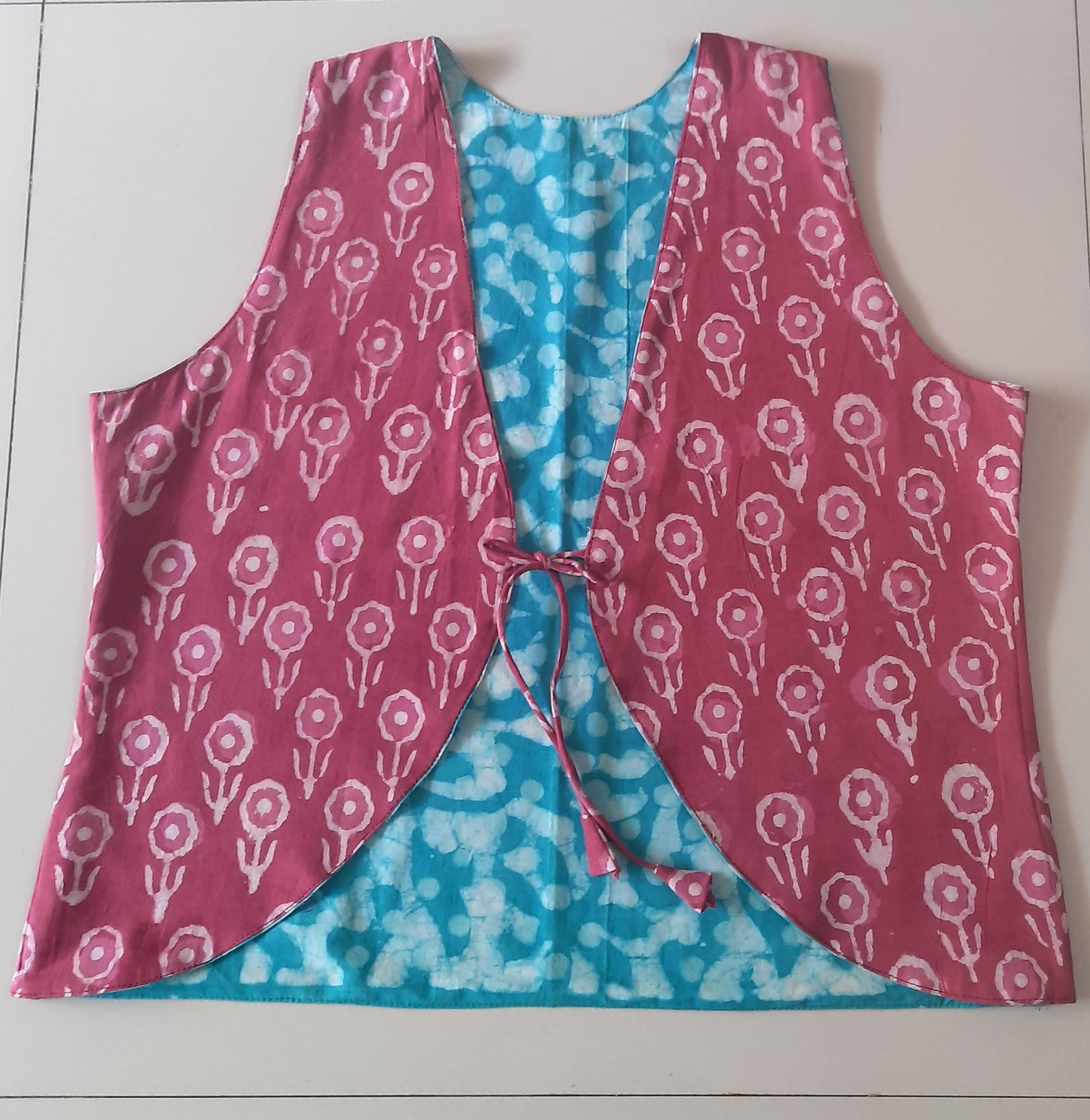 Vest with pink floral pattern on a blue background