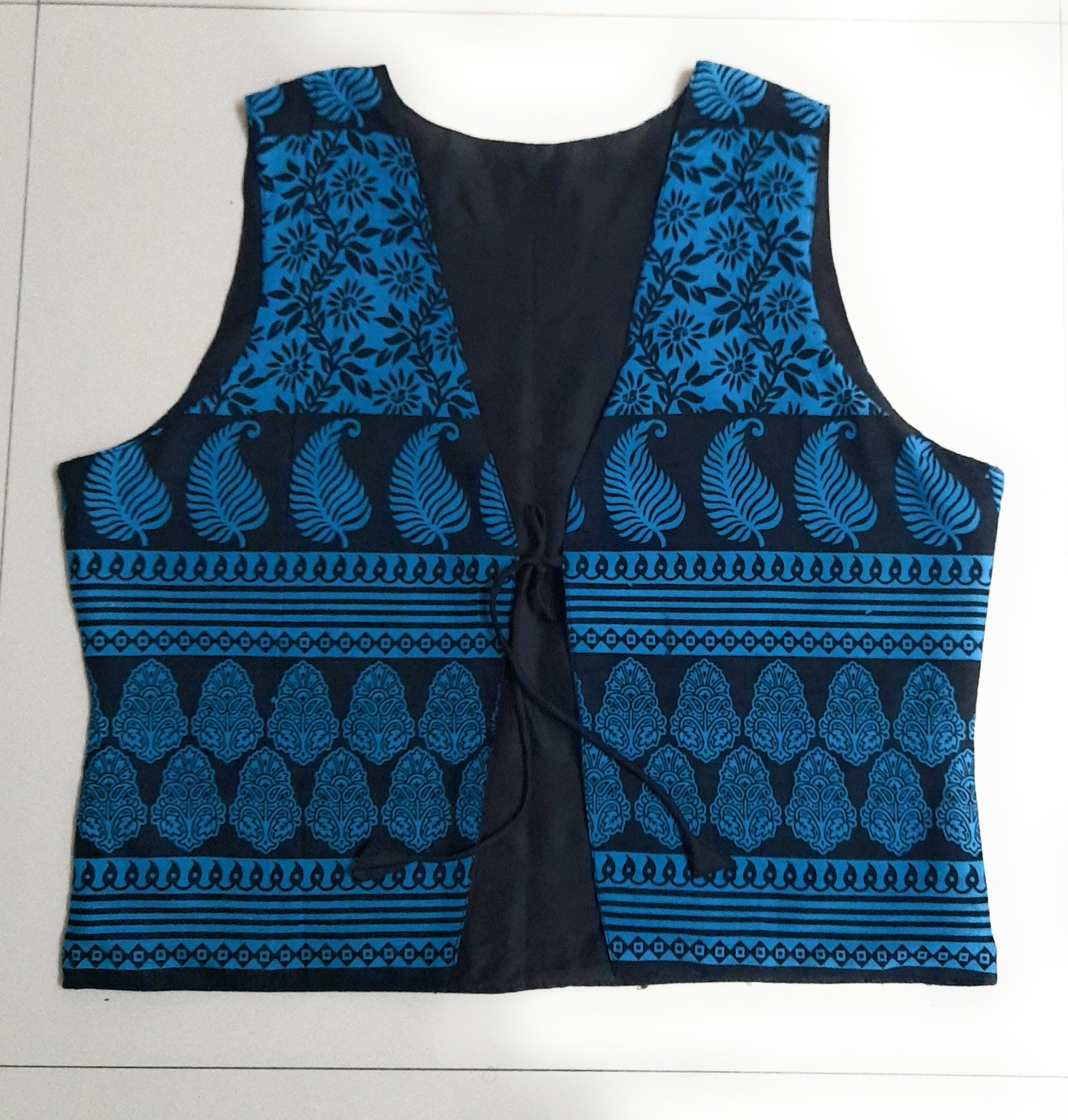 Blue patterned vest on a white background