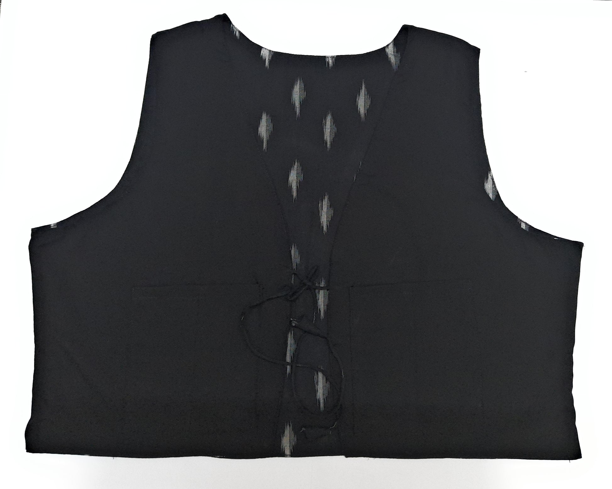 Black sleeveless garment with button details on a white background
