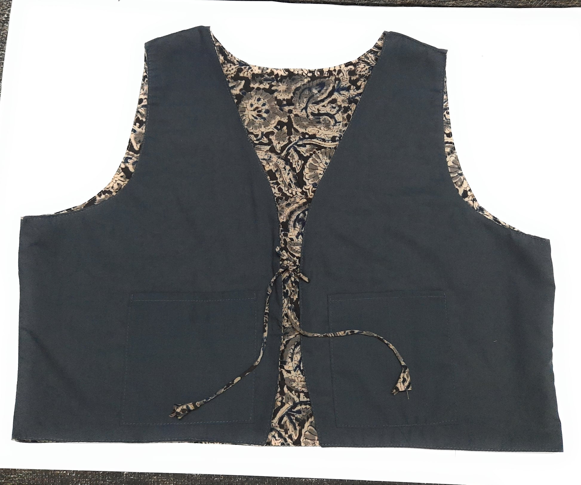 Black vest with camouflage lining on a white background