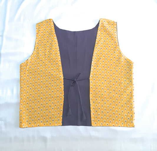 yellow pattern vest with blue lining on a white background