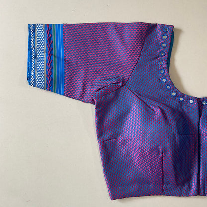 Purple and blue patterned blouse a beige background