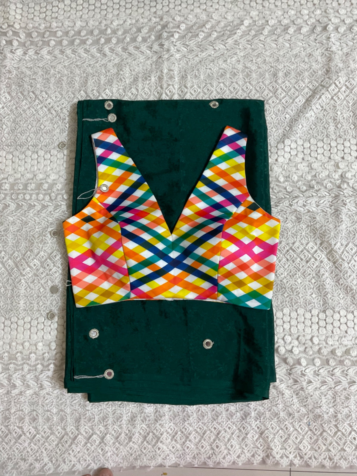 Colourful patterned blouse on a green saree