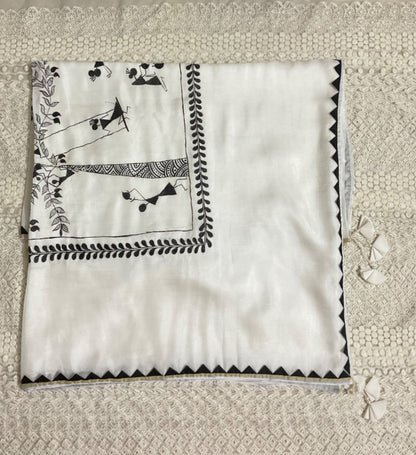 White saree with black embroidery on a textured beige background