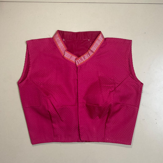 Pink blouse with a textured pattern on a beige background