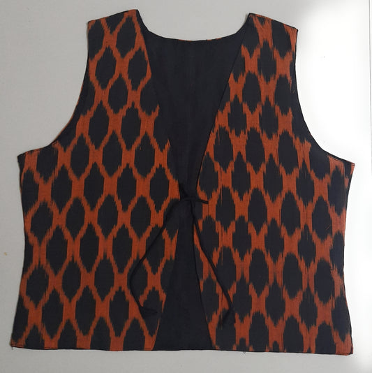 Black and orange patterned vest on a white background