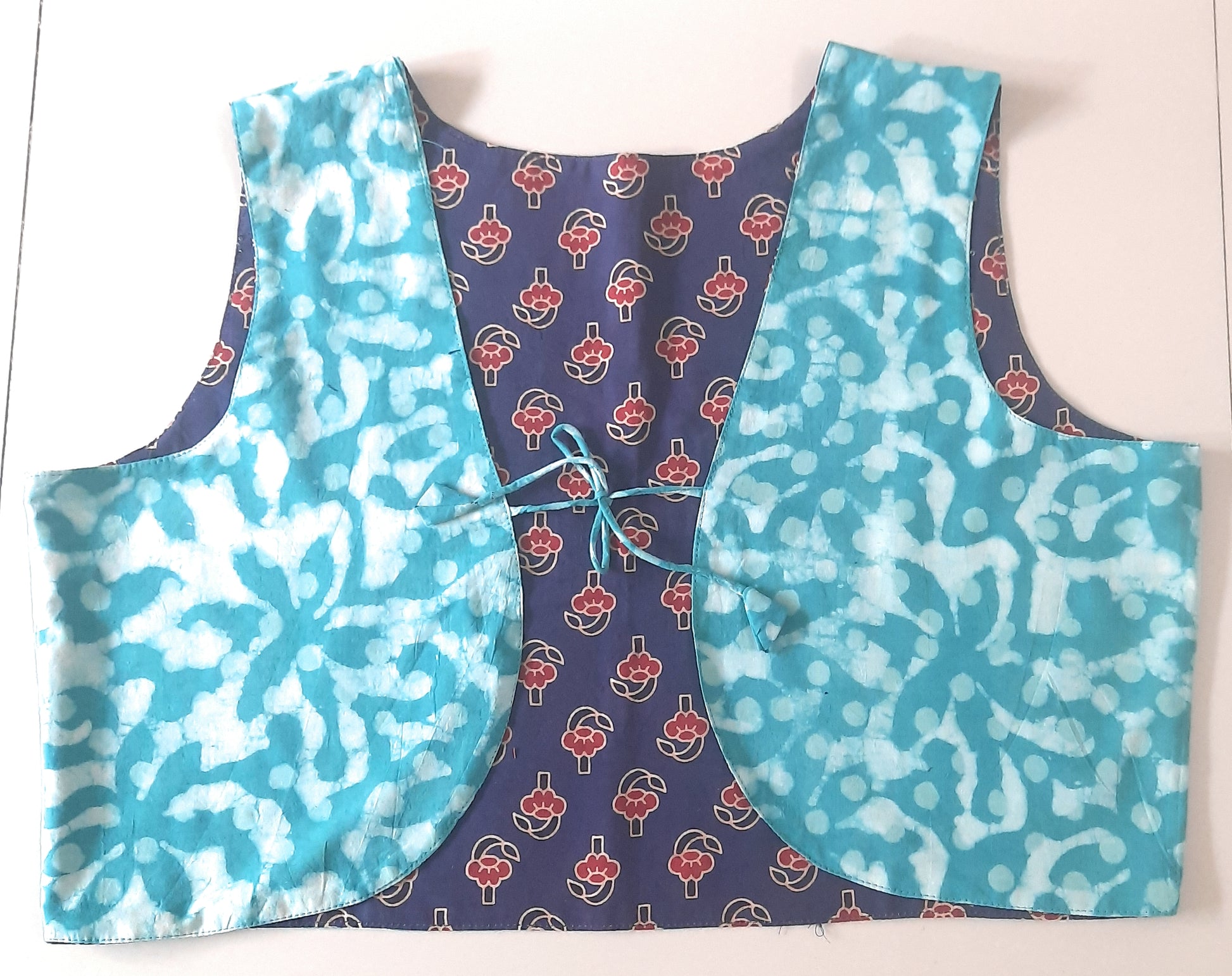 Two-sided patterned vest on a white background