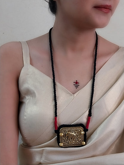 women earing a necklace on a beige saree blouse